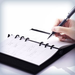 Writing appointments into a planner.